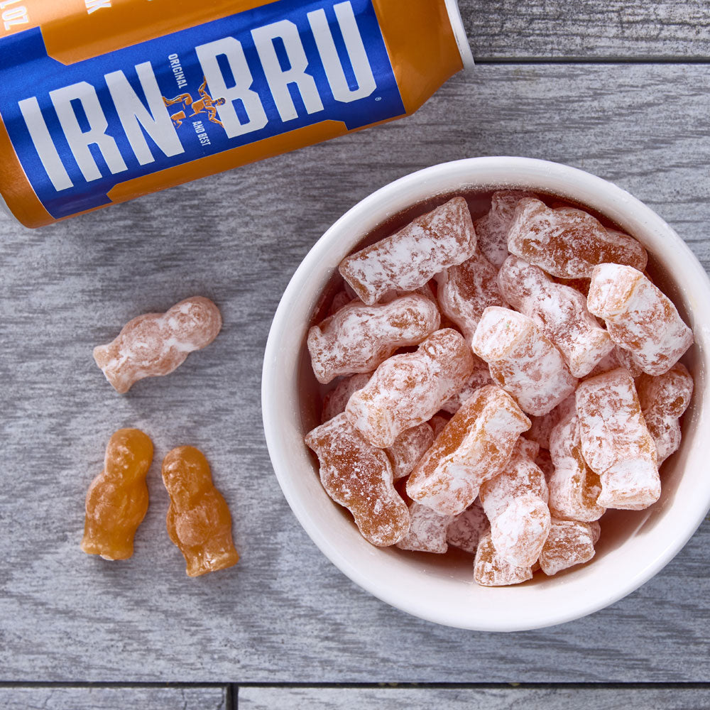 Iron Brew Jelly Babies - small orange shapes coated with powdered sugar.