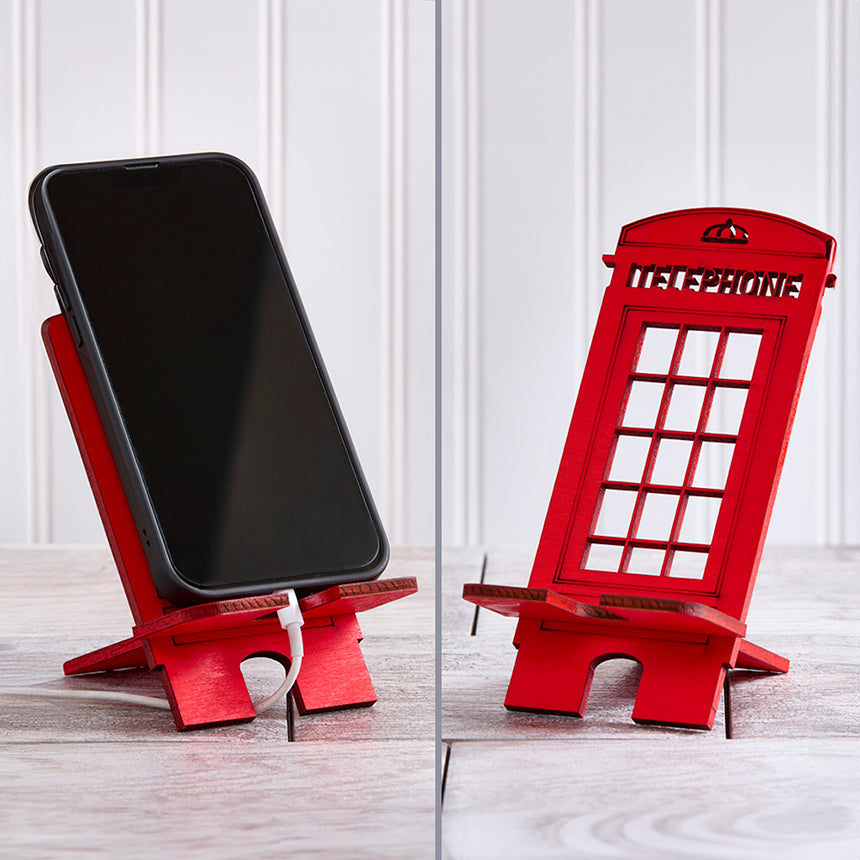 Red wooden cell phone stand in shape of British phone box