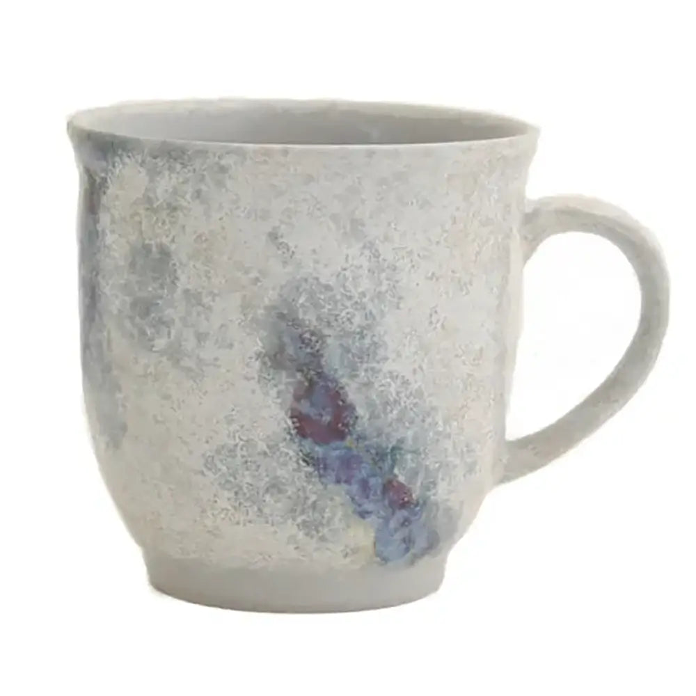 A white ceramic mug with a hand-painted floral pattern in blue and gray shades.